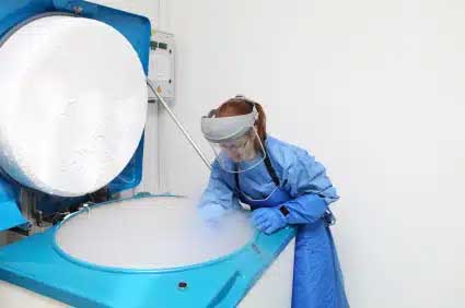 A biobanker accessing biospecimens from a freezer